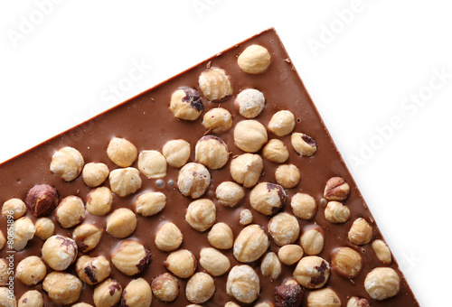 Milk chocolate bar with hazelnuts close up