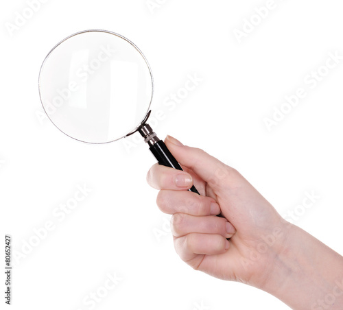 Female hand with magnifying glass isolated on white