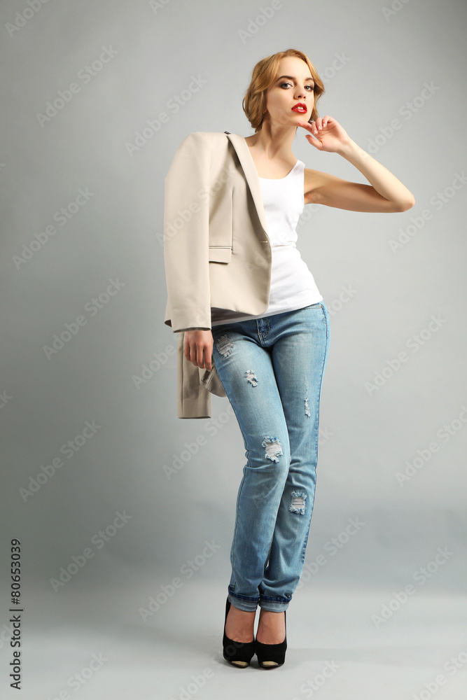 Beautiful young woman in jacket and jeans posing Beautiful young woman in jacket and jeans posing