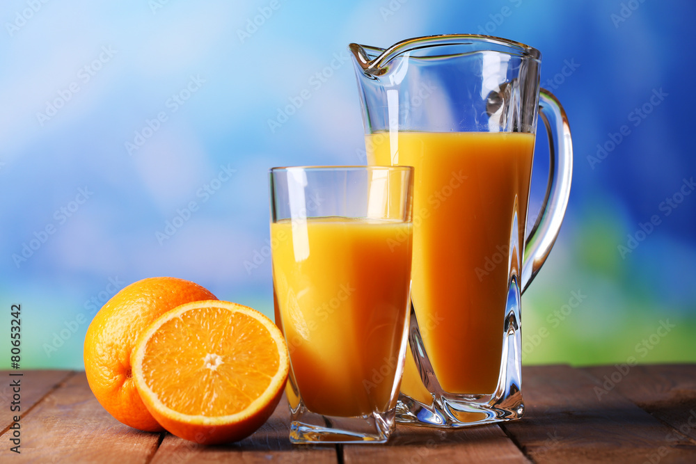 Glass and pitcher of orange juice Glass and pitcher of orange juice