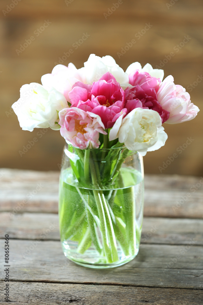 Beautiful tulips in glass vase on wooden background Stock Photo | Adobe