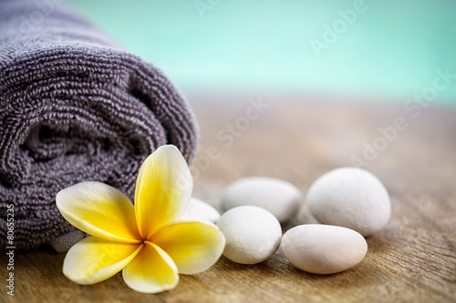 White frangipani on towel in the spa
