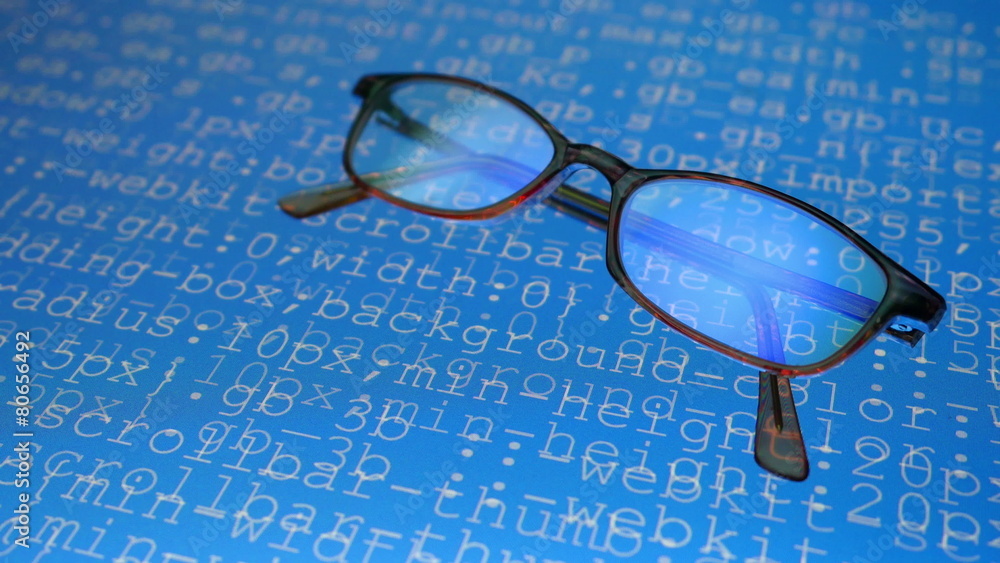 Glasses. Computer program codes running in a scrolling motion Glasses. Computer program codes running in a scrolling motion