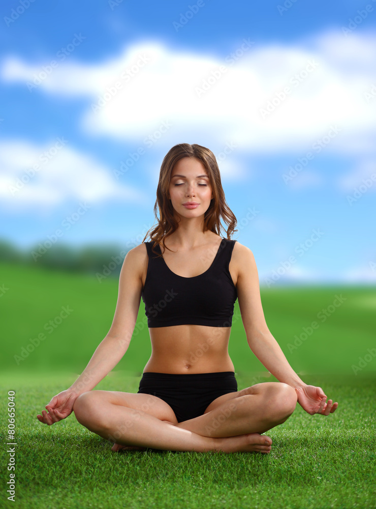 Young woman practicing yoga in the lotus position Young woman practicing yoga in the lotus position