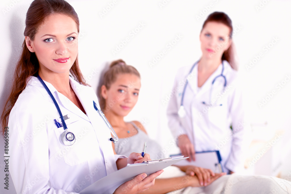 Smiling female doctor with a folder in uniform standing at Smiling female doctor with a folder in uniform standing at