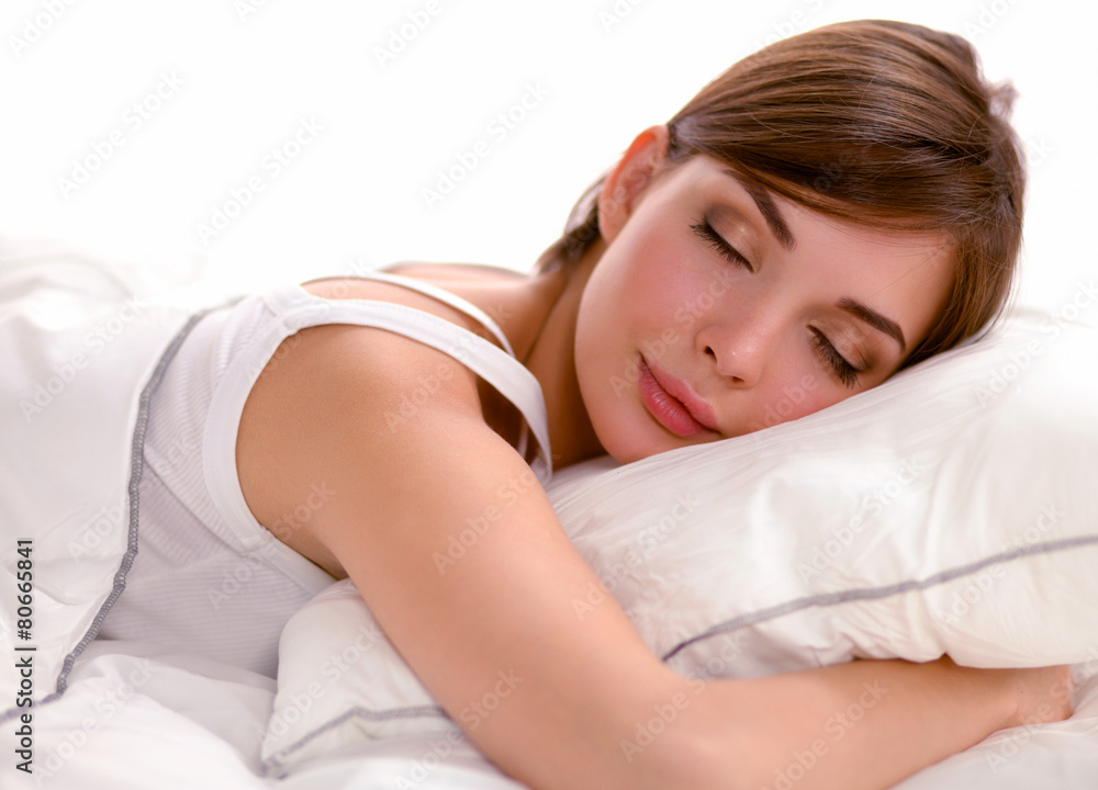 Beautiful girl sleeps in the bedroom, lying on bed Beautiful girl sleeps in the bedroom, lying on bed