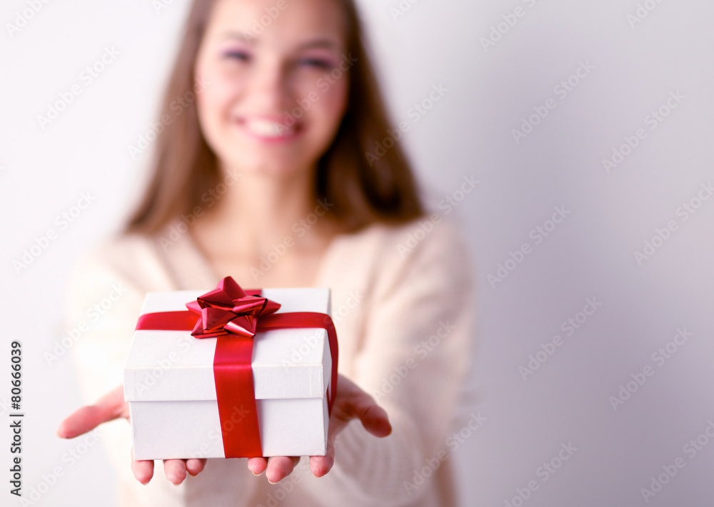 Young woman happy smile hold gift box in hands,standing over Young woman happy smile hold gift box in hands,standing over