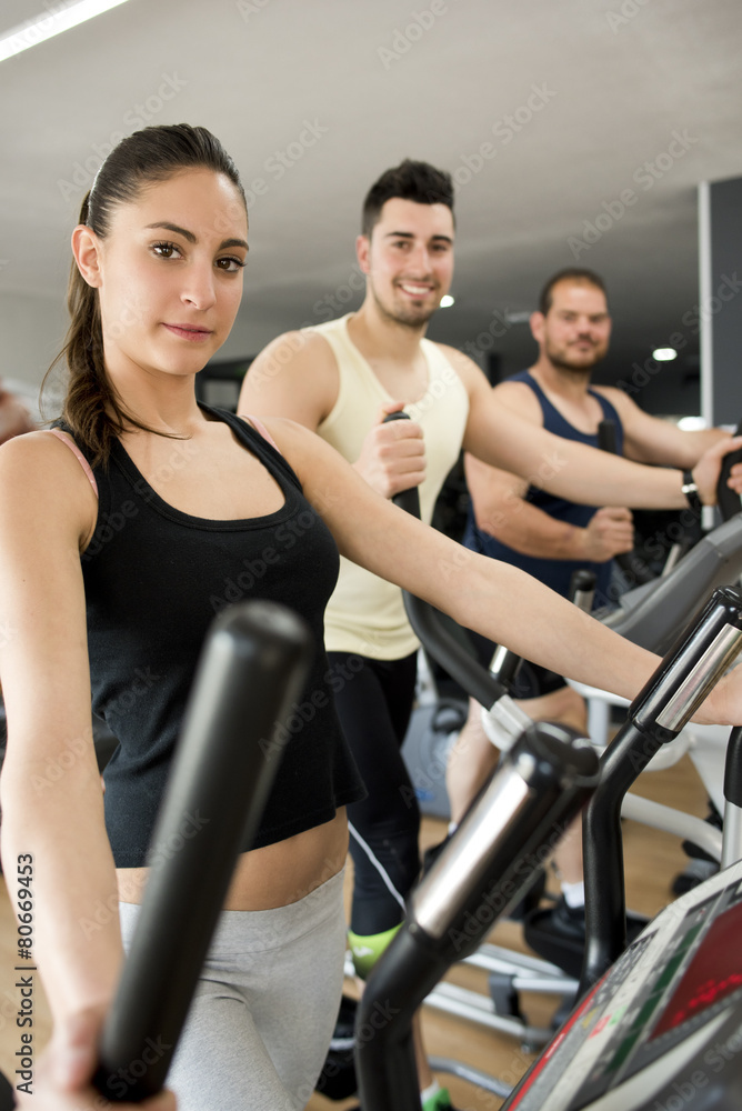 Fototapeta premium People training at cross trainer elliptical bike