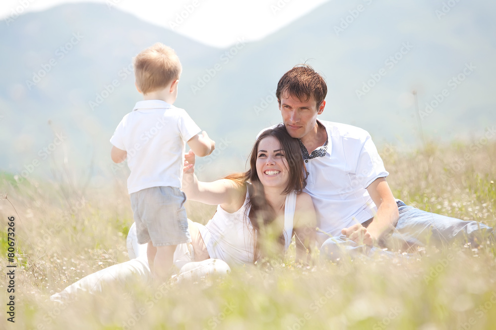 Family playing with son in the flowers field Family playing with son in the flowers field