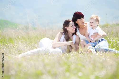 Family playing with son in the flowers field
