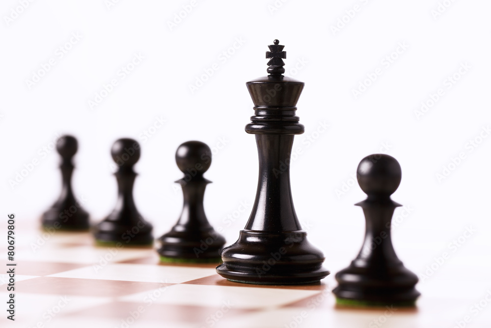 Black chess pieces on a chessboard isolated Black chess pieces on a chessboard isolated