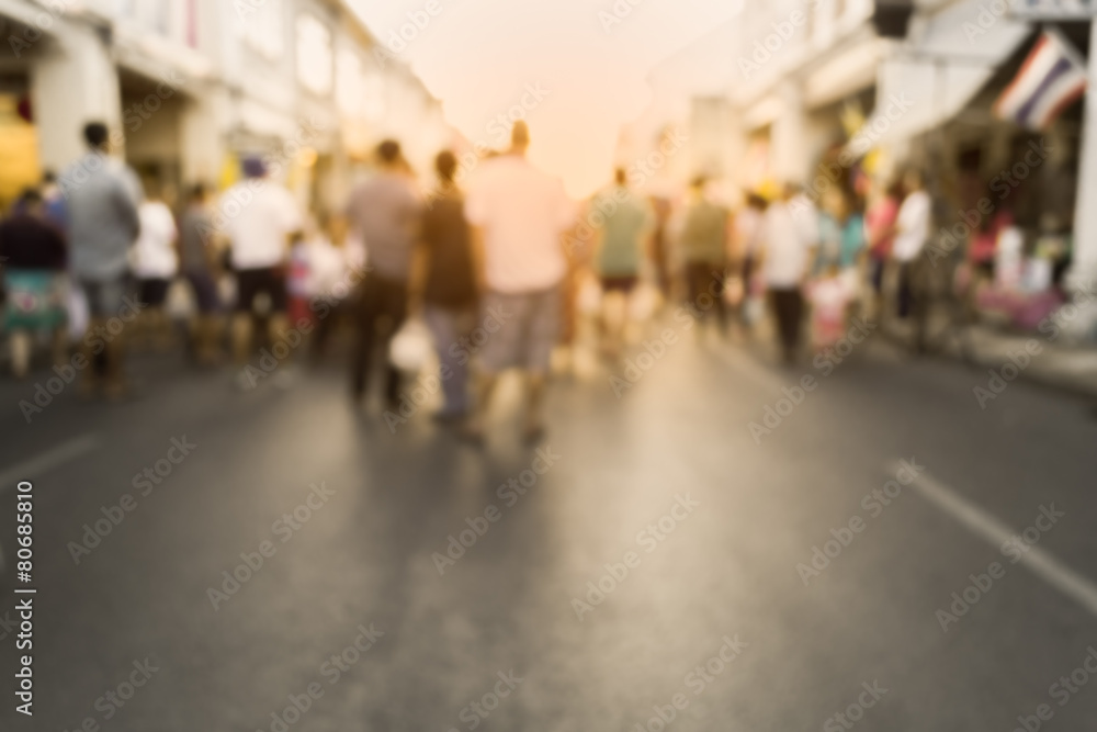 Blurred people watching a performance on the street