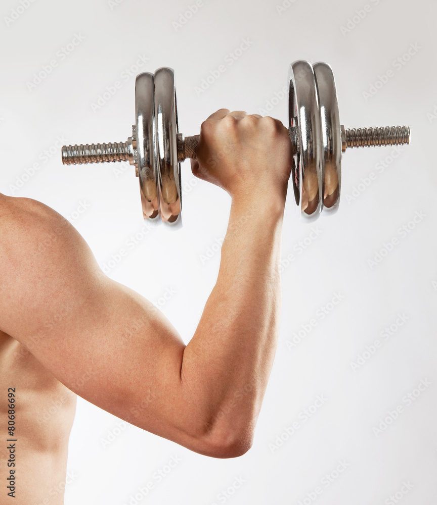 Hand holding chrome dumbbell on the white background. Hand holding chrome dumbbell on the white background.