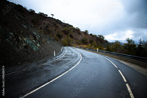 Asphalt road in the mountains. Winter. Rain. Toned © strannik_fox