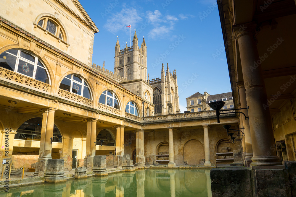 BATH, ENGLAND - NOVEMBER 22, 2014: Roman Baths with Bath Abbey i