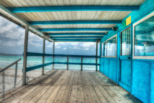 wooden terrace by the shore in Sardinia in hdr