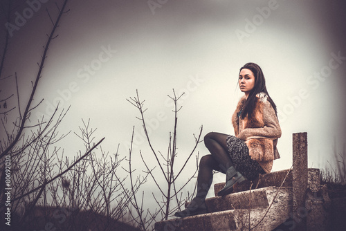 Long hair brunette girl outdoor with old industrial view behind,