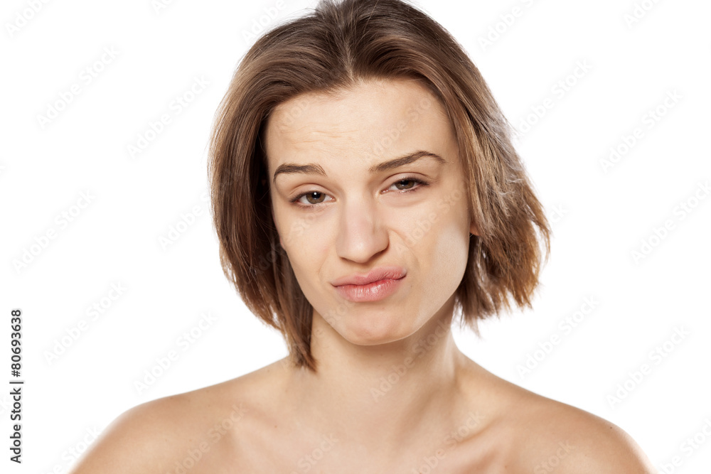 young beautiful woman with a suspicious gesture young beautiful woman with a suspicious gesture
