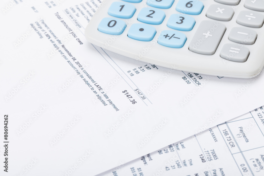 Neat calculator with utility bill under it Neat calculator with utility bill under it