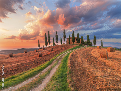 Beautiful Tuscany landscape with traditional house and hay bales