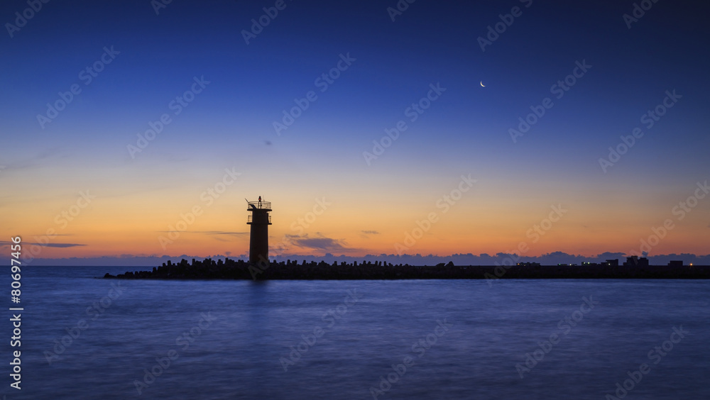 lighthouse with moon on the sky