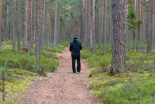 Man in black walks in the forest © gorelovs
