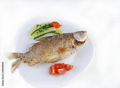 fried fish with cucumbers, tomatoes and herbs