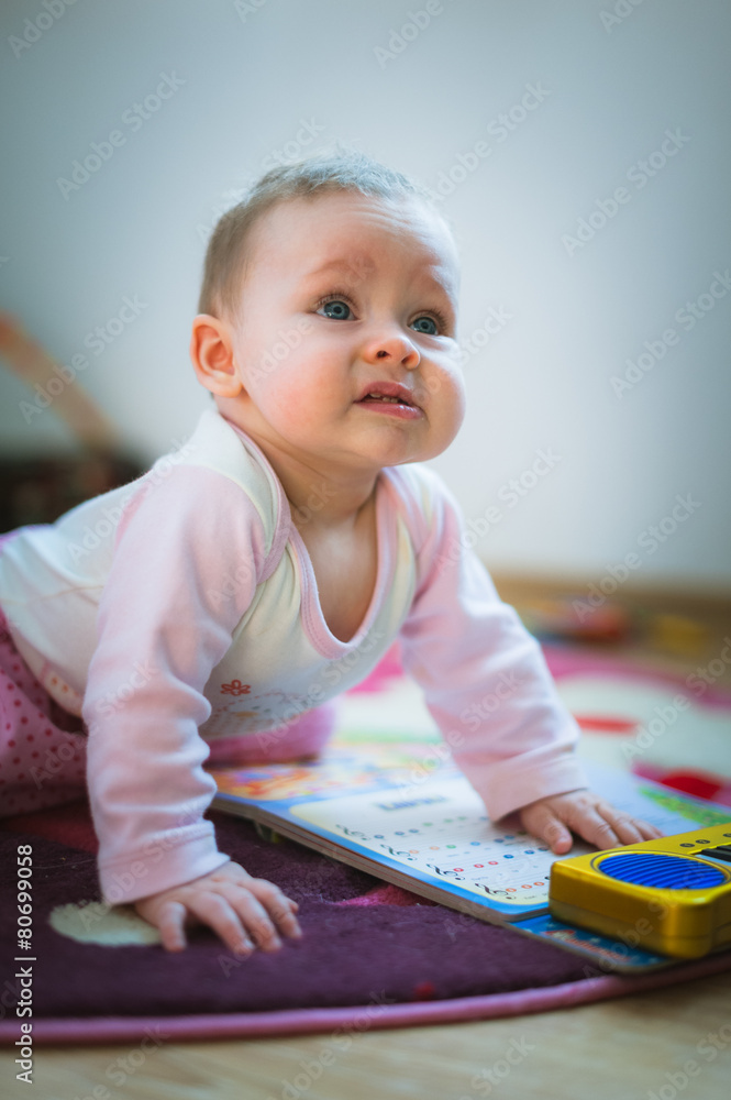 Adorable baby girl crawls on all fours floor at home Adorable baby girl crawls on all fours floor at home