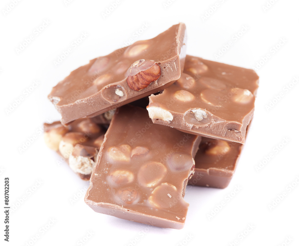 Milk chocolate with hazelnuts on white background Milk chocolate with hazelnuts on white background
