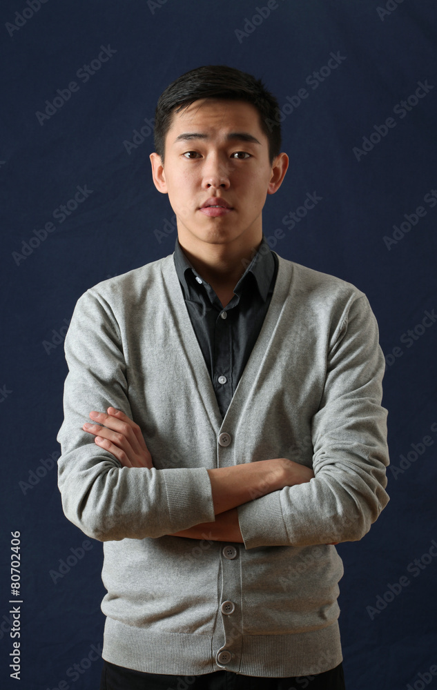 Young Asian man looking at camera