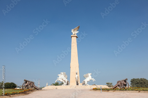 Statue with falcon and horses in Umm Al Quwain, UAE photo