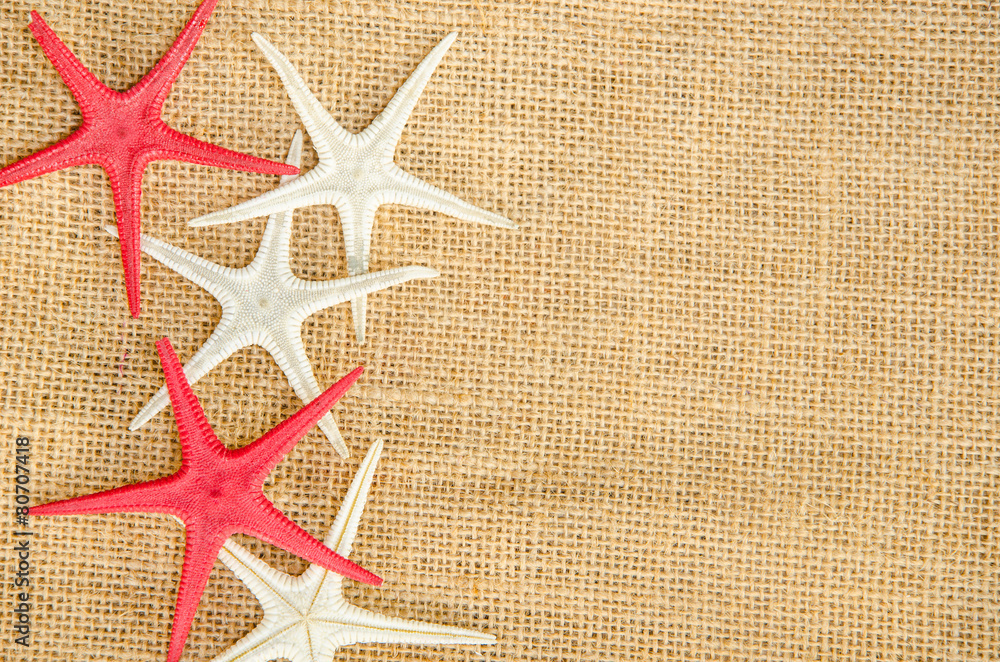 Star fish on light natural linen texture Star fish on light natural linen texture