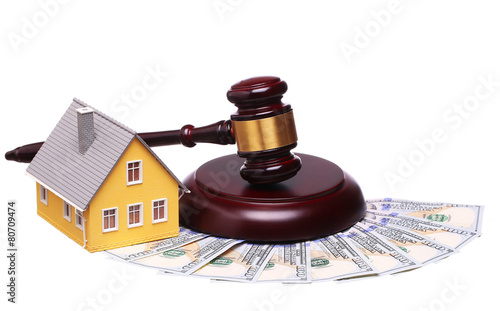 Concept of house sale with gavel and money isolated on white