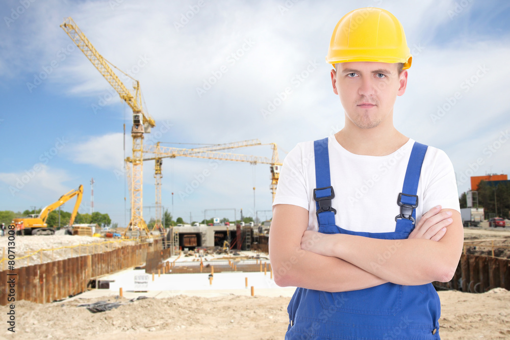 portrait of young handsome man in builder uniform portrait of young handsome man in builder uniform