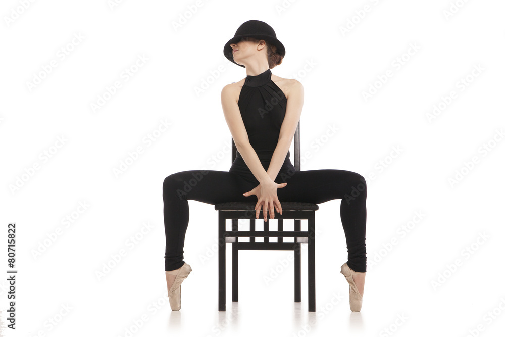 Fototapeta premium Pretty young ballerina sitting on the chair