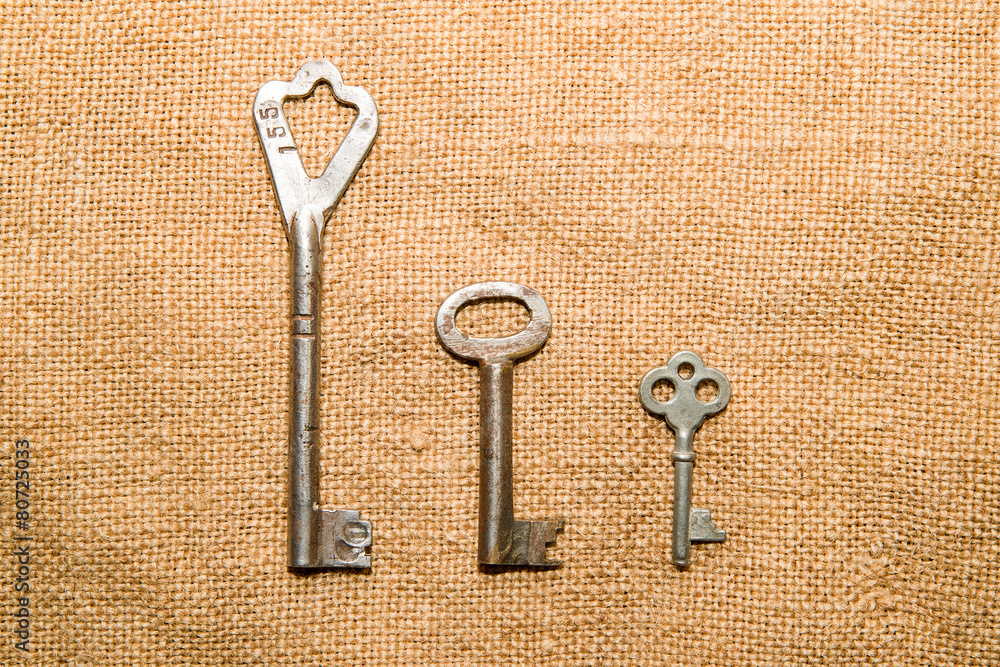 Three old keys to the safe on a very old cloth Three old keys to the safe on a very old cloth