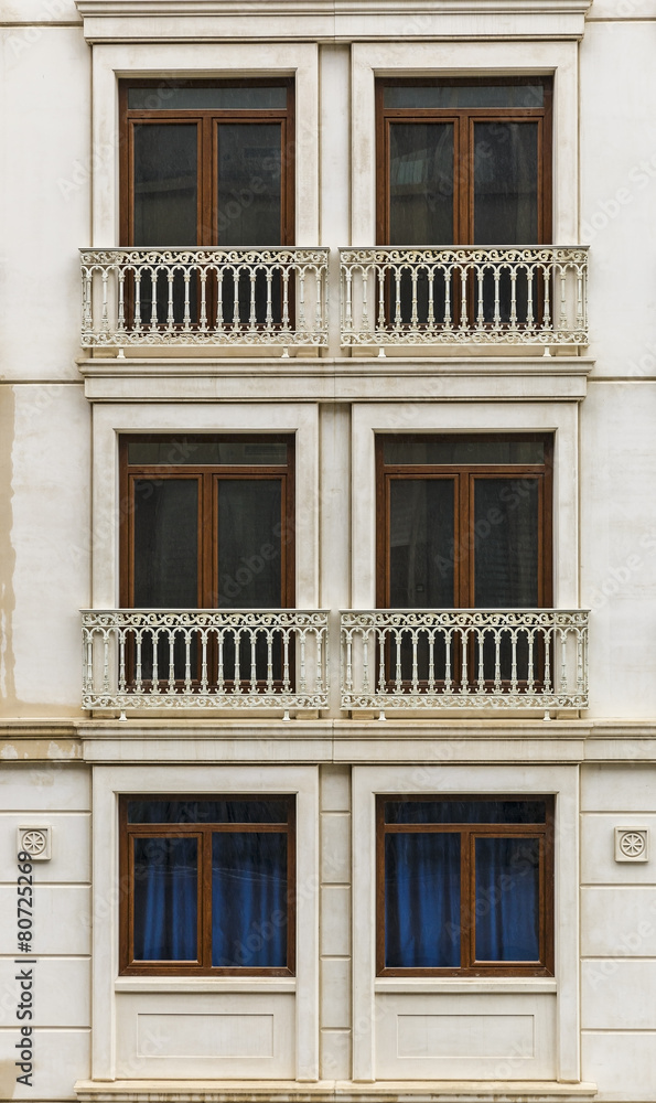 Facade of a building with windows and balconies Facade of a building with windows and balconies