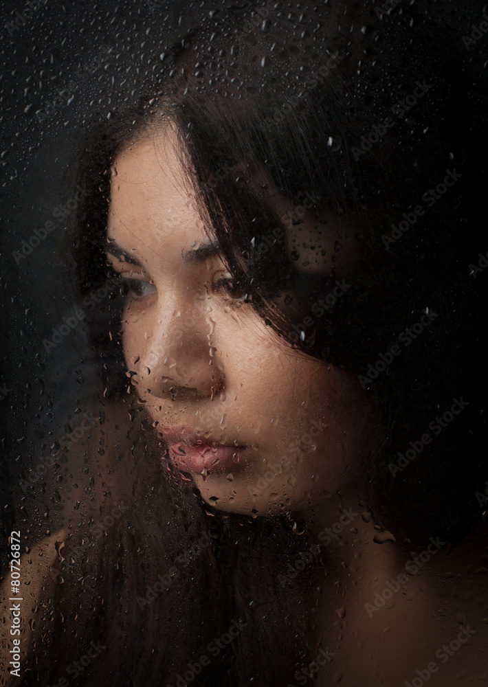 A beautiful girl in a white t-shirt, on a black background behin A beautiful girl in a white t-shirt, on a black background behin