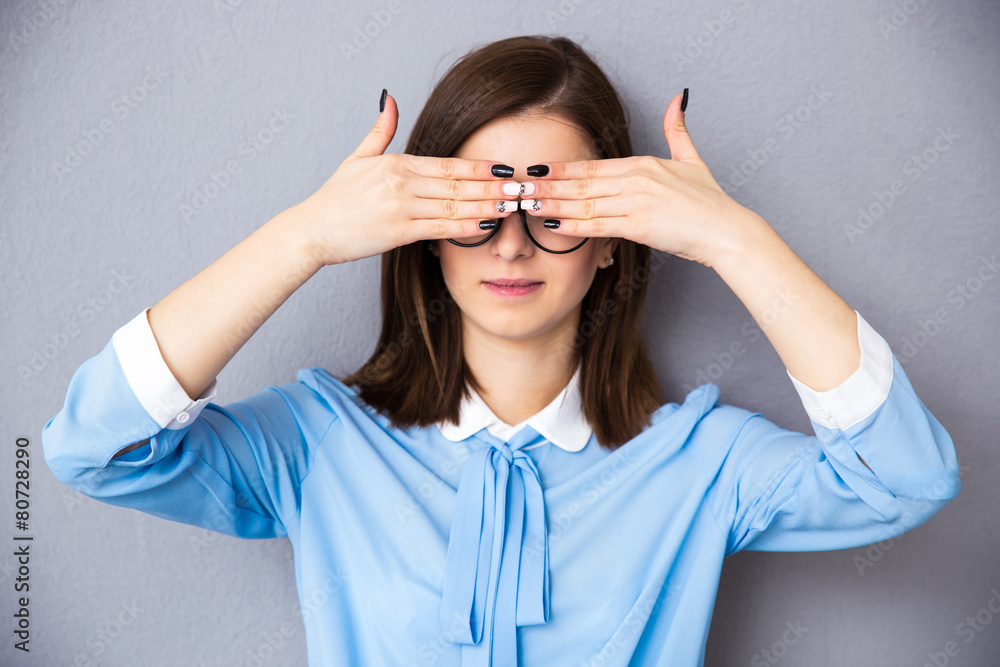 Businesswoman covering her eyes Businesswoman covering her eyes