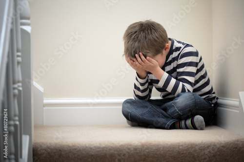 Upset problem child sitting on staircase © Brian Jackson