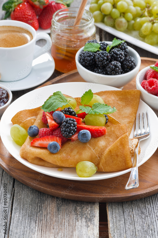 breakfast - crepes with fresh berries and honey, coffee breakfast - crepes with fresh berries and honey, coffee