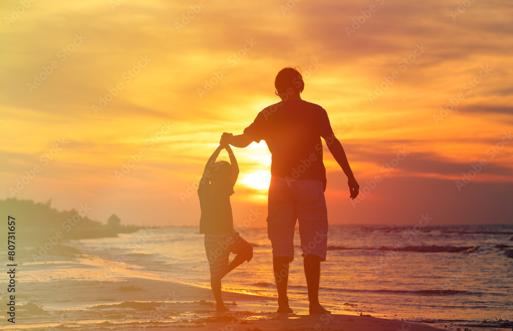 Fototapeta premium father and son doing yoga at sunset sea
