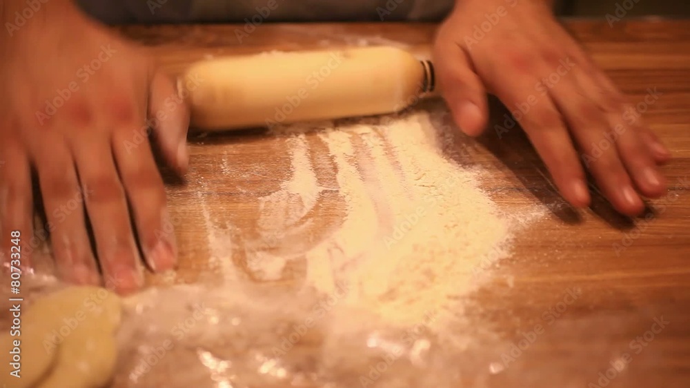 male chef hands preparing dough with rolling pin for asian food male chef hands preparing dough with rolling pin for asian food