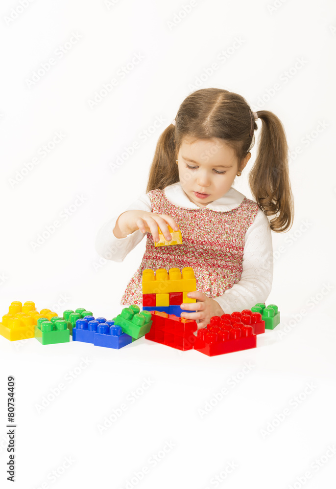 Little girl playing with construction blocks Little girl playing with construction blocks