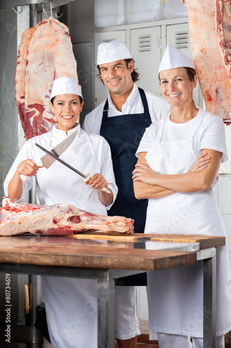 Confident Butchers Standing At Counter