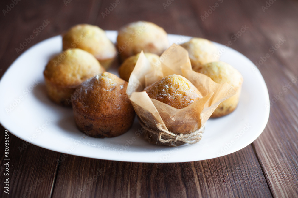 Homemade muffins in plate on wood table Homemade muffins in plate on wood table