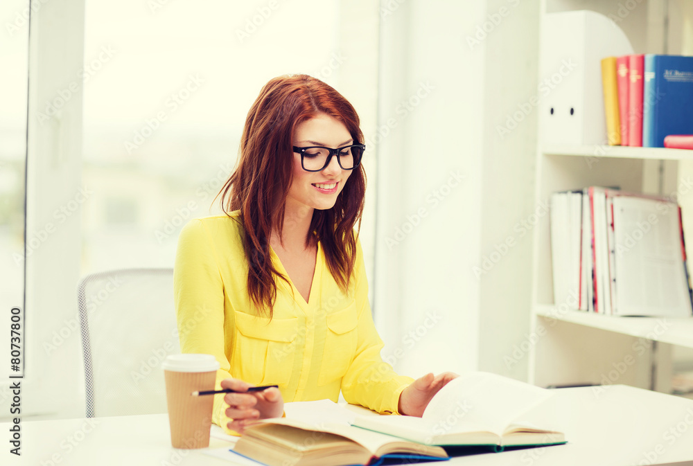 smiling student girl reading books in library smiling student girl reading books in library