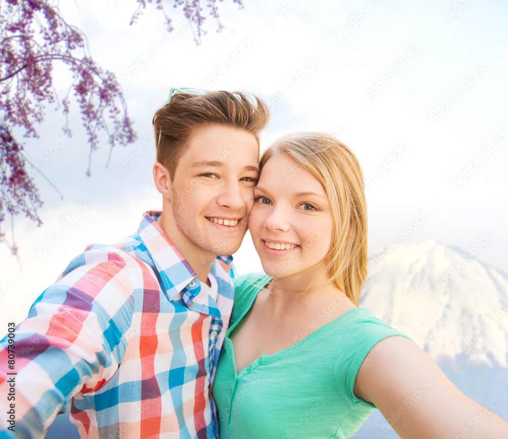 smiling couple with smartphone in city smiling couple with smartphone in city