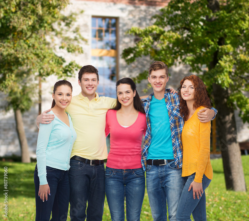 group of smiling teenagers over campus background