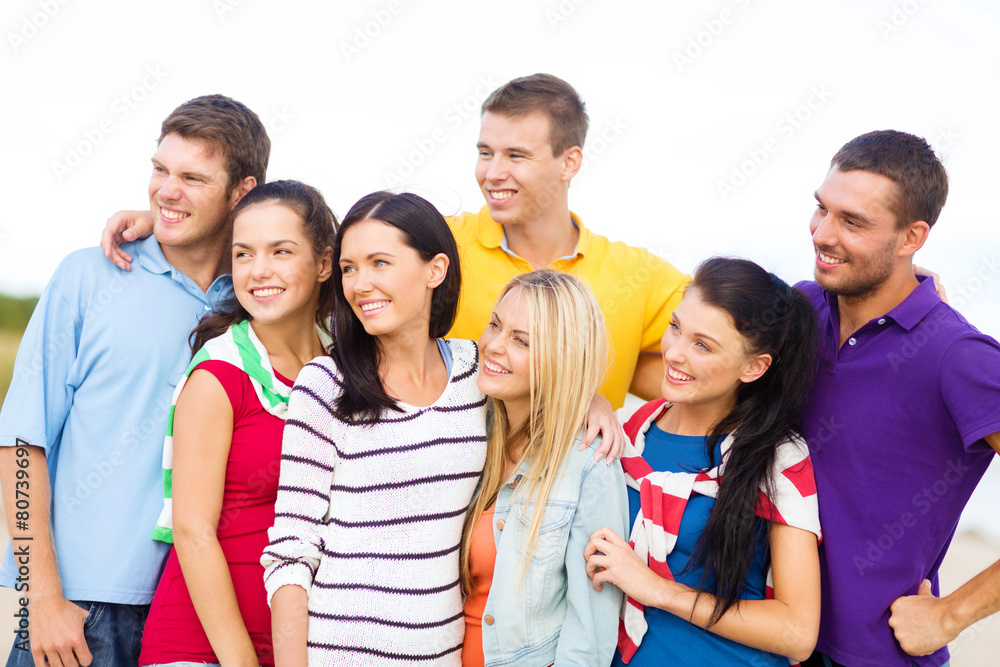 group of happy friends hugging on beach group of happy friends hugging on beach